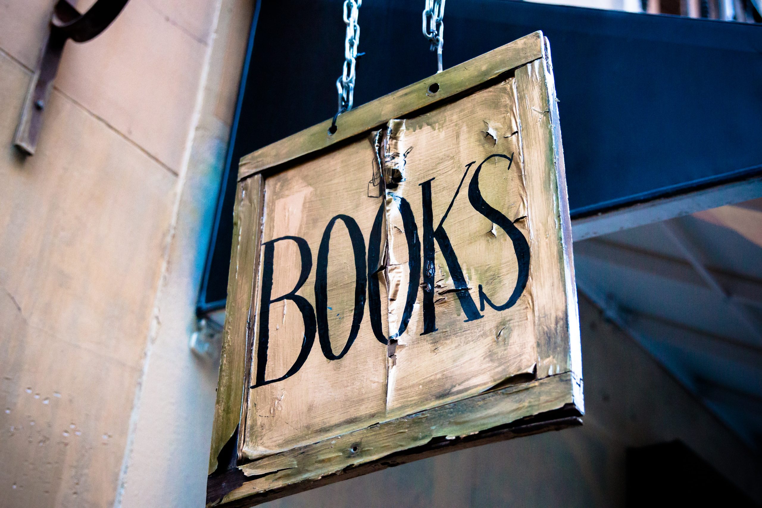In an article about The StoryGraph, a picture of a wooden sign that says Books on it.