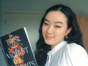 Chloe Gong with a copy of These Violent Delights