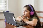 in article about games in online learning, a child looking at their laptop