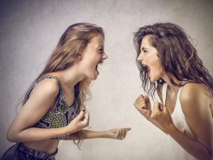 Two women yelling at each other.