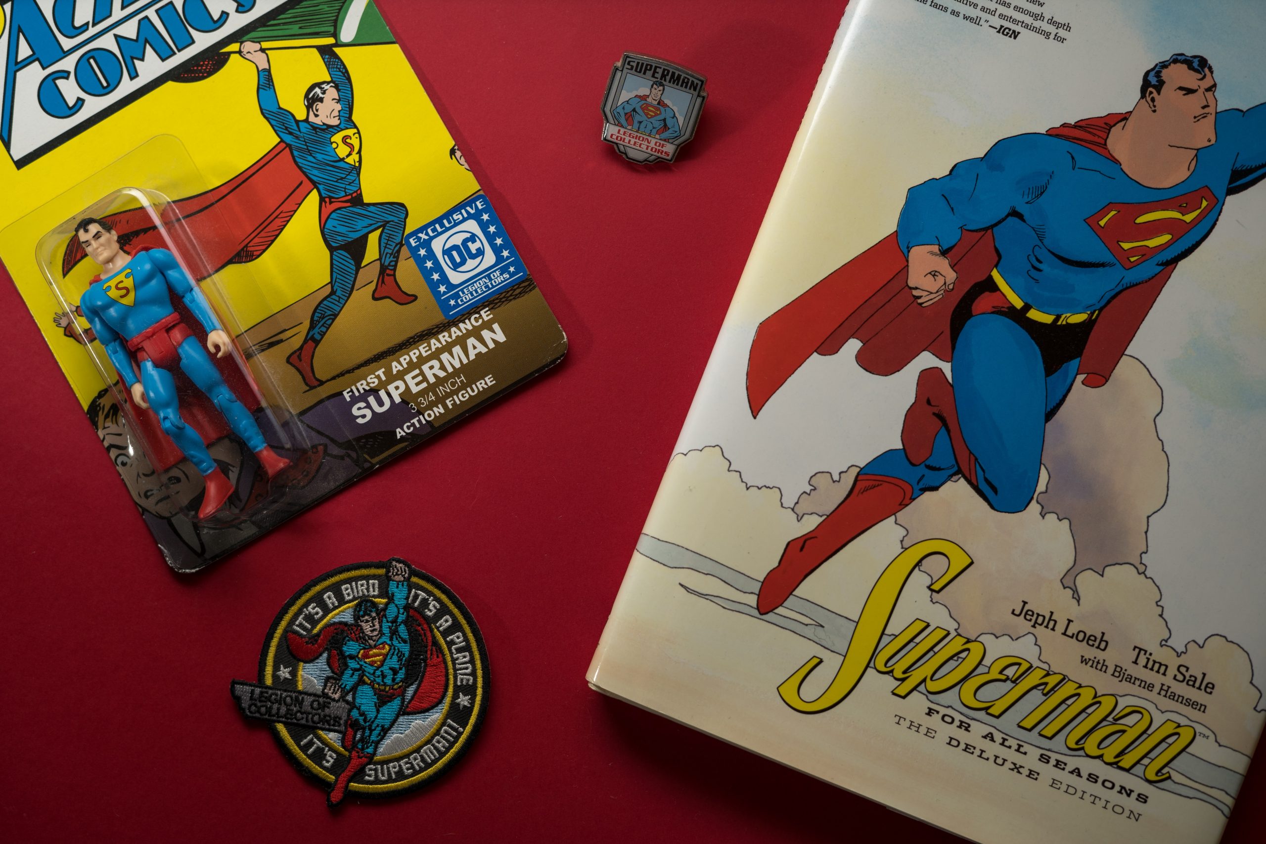 A Superman comic and merchandise lay on a table
