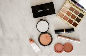 Different makeup products on table