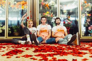 The Band Camino sitting on the floor of a flower shop