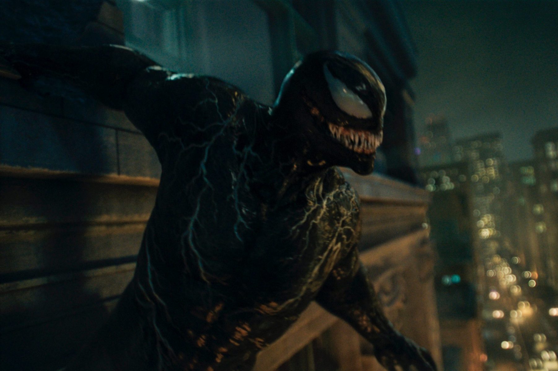 Venom 2 screenshot, of Venom hanging from a building