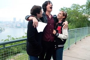 in article about movies for college students, a still from the movie "The Perks of Being a Wallflower" of the three main characters Charlie, Sam, and Patrick hugging.