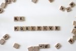 Scrabble pieces spelling out be positive in an article about toxic positivity