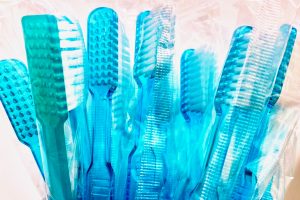 in article about dental health, a row of toothbrushes