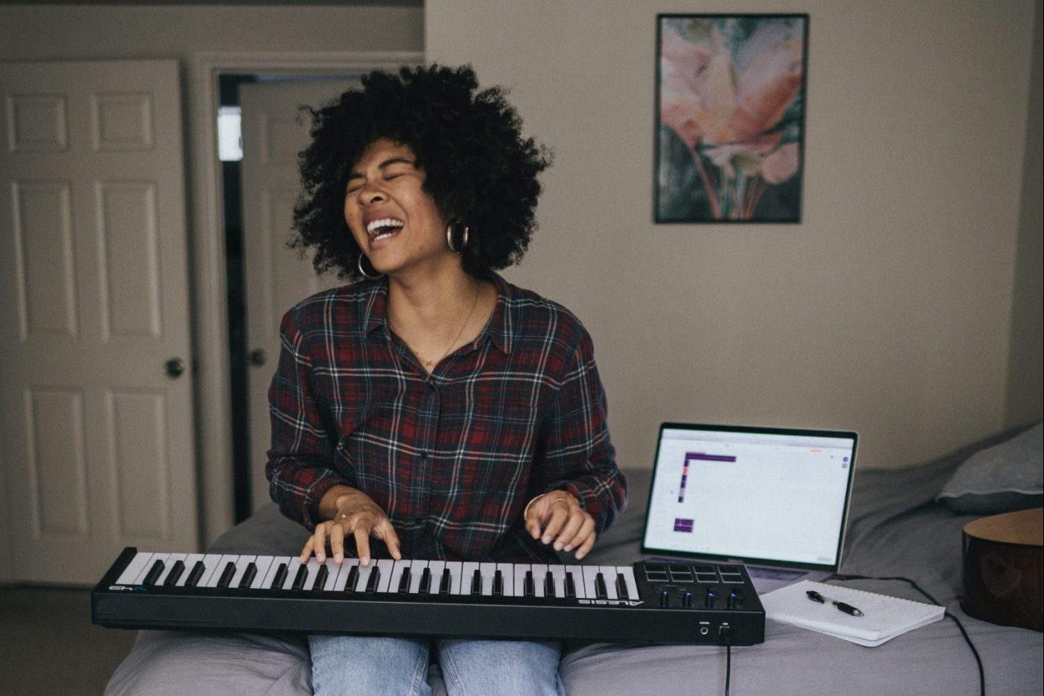 musician playing keyboard in bedroom