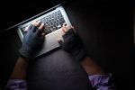 In an article about cybercrimes on social media apps a picture of hands typing on a laptop