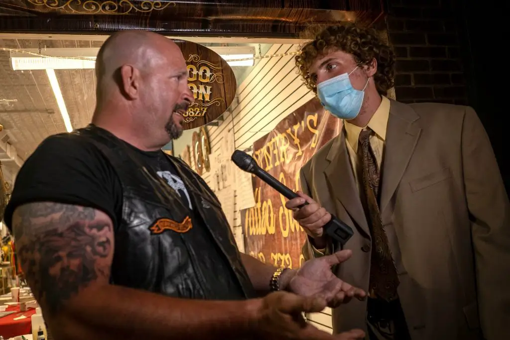 Photo of Andrew Callaghan interviewing someone for All Gas No Brakes
