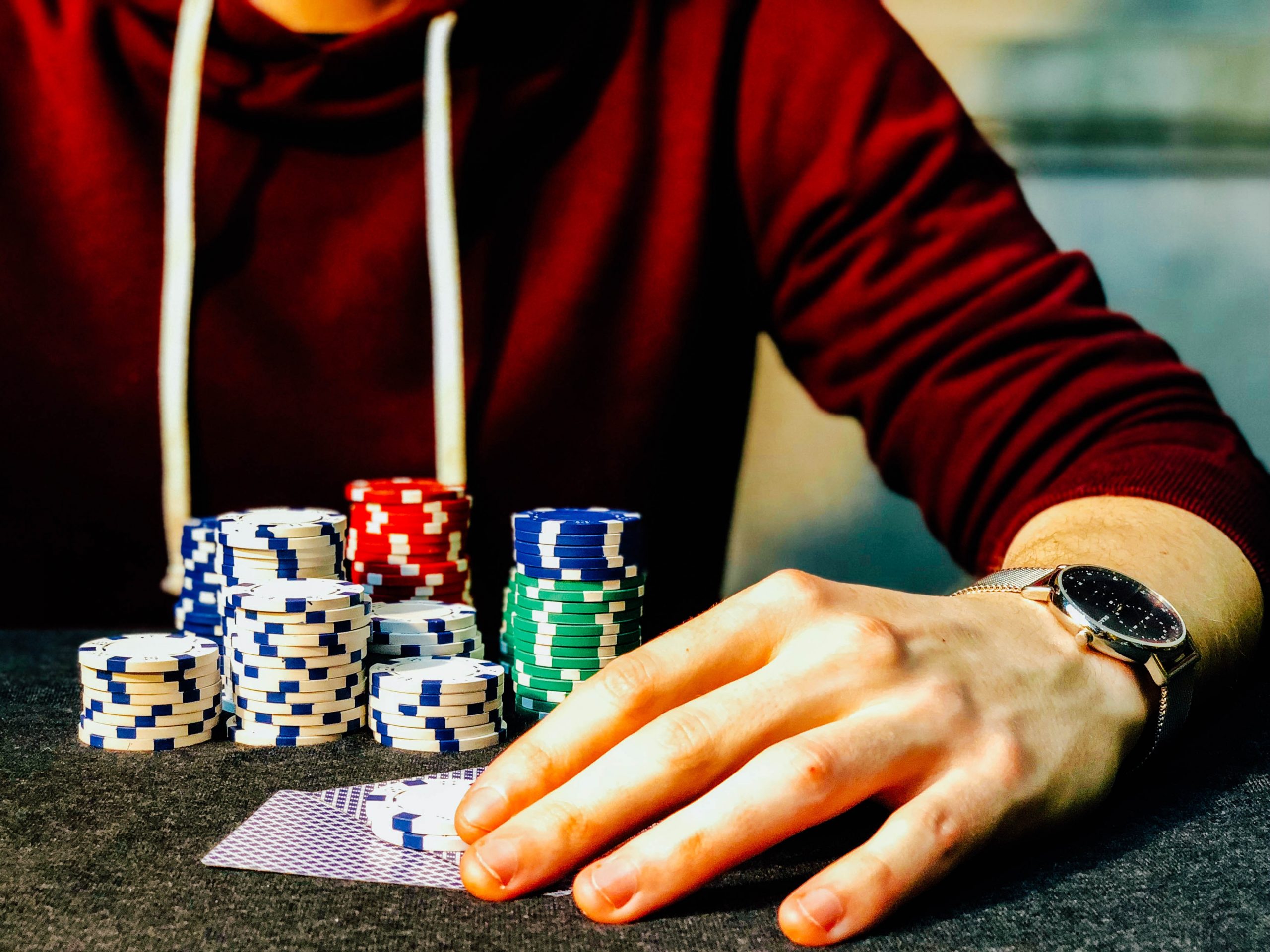 in article about NeonVegas, a person with casino chips and cards in front of them