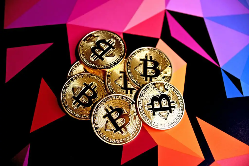 bitcoin tokens against a colorful background