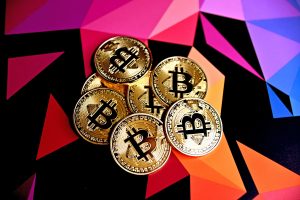 bitcoin tokens against a colorful background