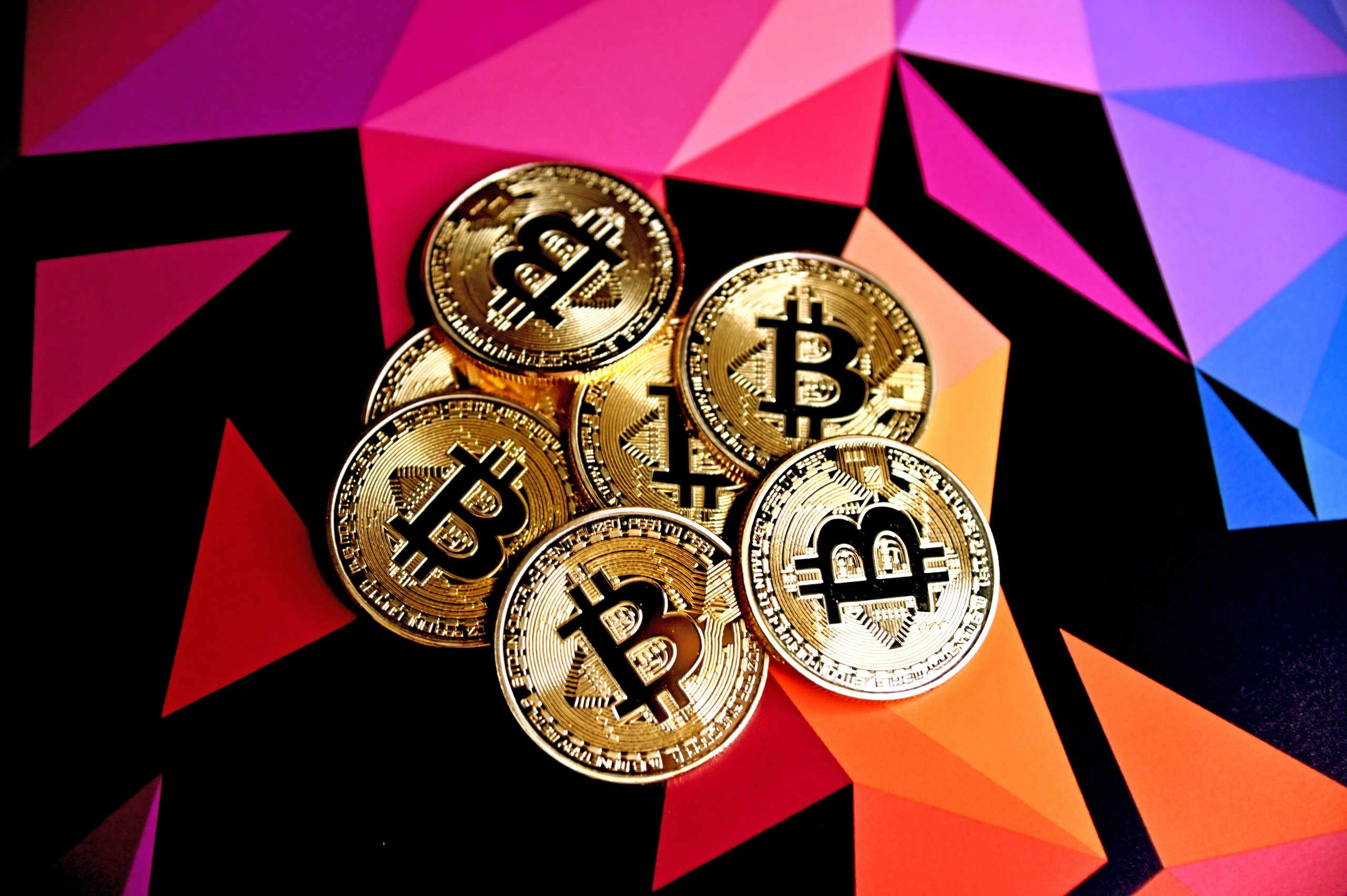 bitcoin tokens against a colorful background