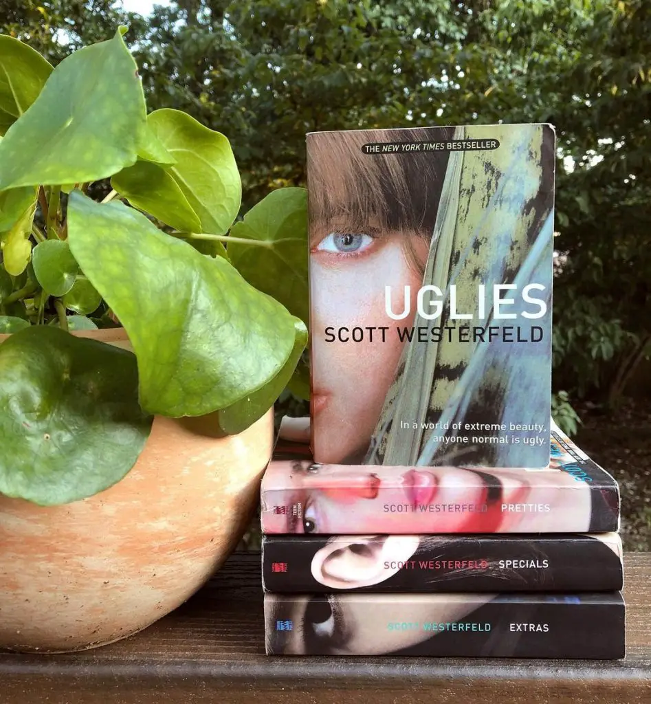copies of the Uglies book series next to a potted plant