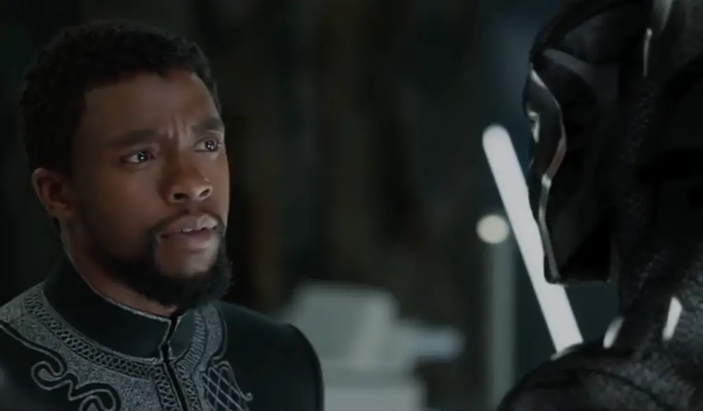Chadwick Boseman, as T'Challa, looking at the Black Panther suit for an article about the #RecastTChalla petition.