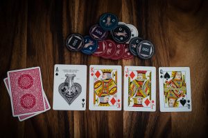 in article about no deposit casinos, four cards face up on a table next to some chips