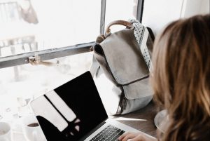 in an article about essay writing, a person typing on a latpop