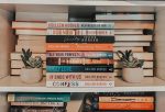 colleen hoover books stacked on shelf