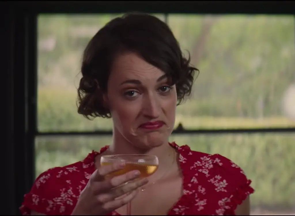 Phoebe Waller-Bridge in the show Fleabag, holding a glass of wine.