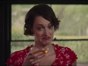 Phoebe Waller-Bridge in the show Fleabag, holding a glass of wine.