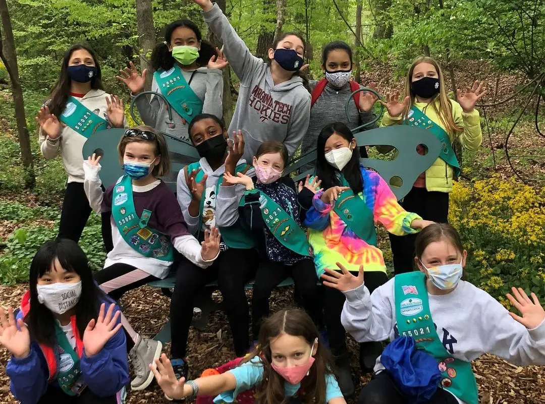 A group photo of junior Girl Scouts in the outdoors
