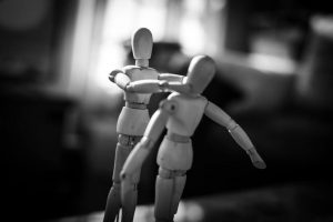 in an article about conflict, Two wooden anatomy dolls physically fighting.