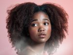 In article about hair relaxers, a headshot of young woman modeling natural hair