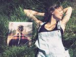 Taylor Swift on the grass next to a Taylor Swift record