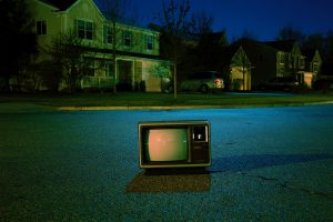 TV on a suburban street represents the corrupt view of the simple life.