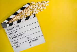 Clap board with popcorn on a yellow background
