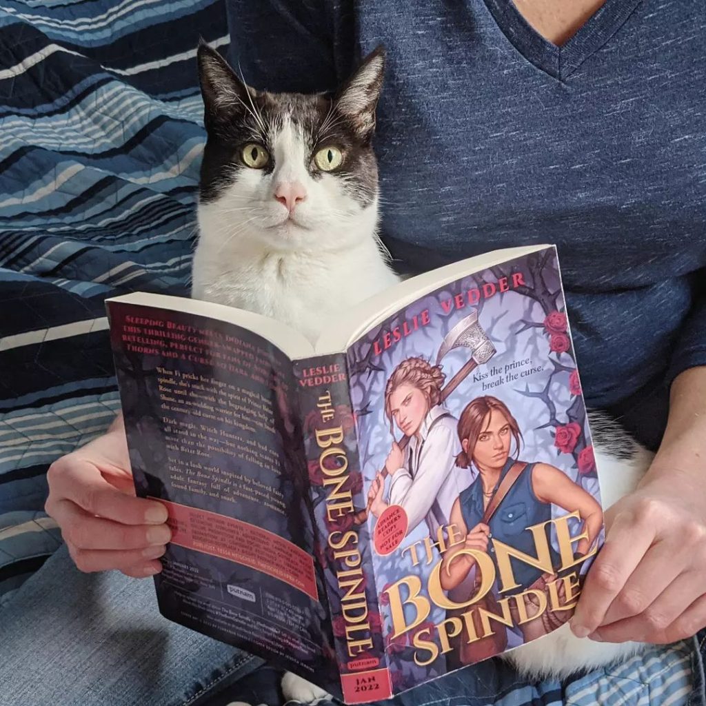 Leslie Vedder and cat reading the Bone Spindle