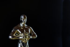 in article about Will Smith slap of Chris Rock, an Oscar against a black background