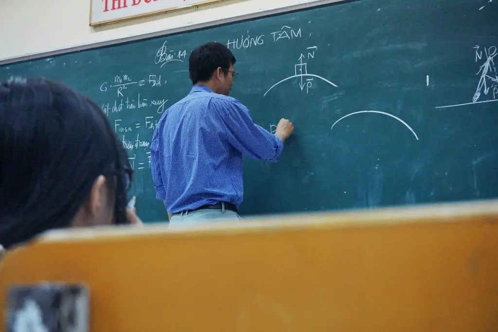 in article about professors, a professor at a blackboard