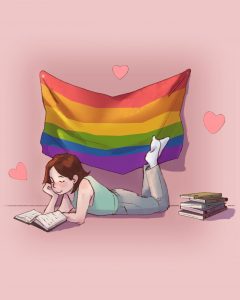 girl reading with pride month flag behind her
