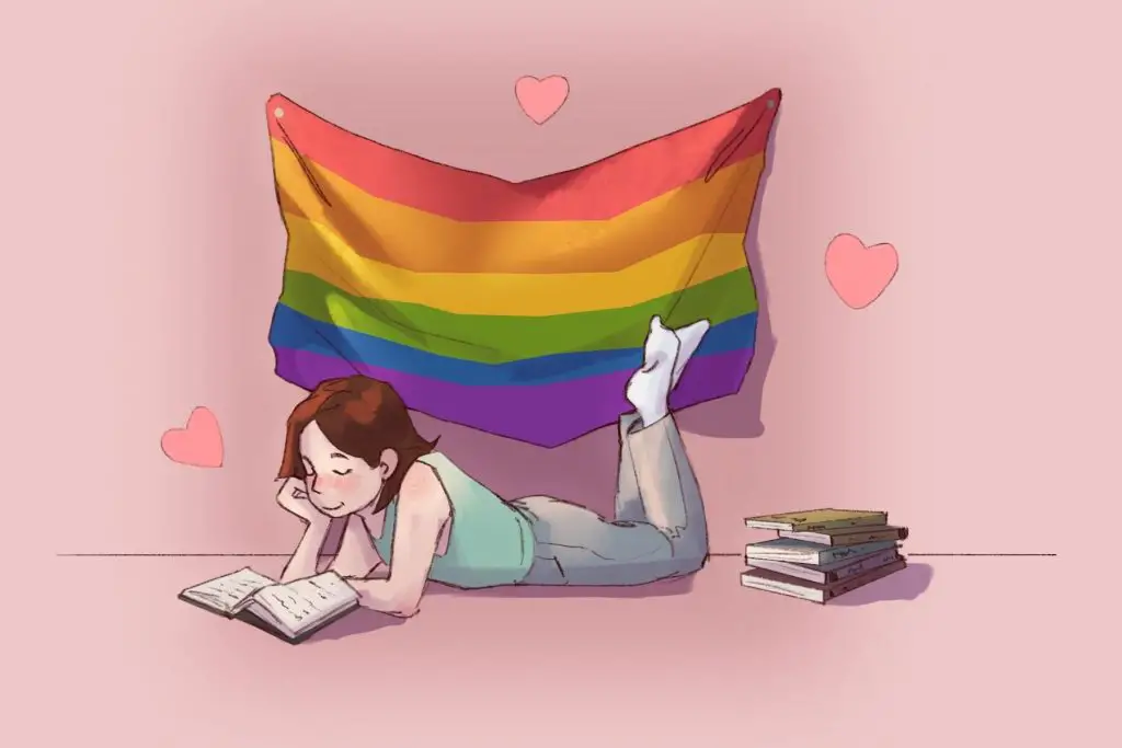 girl reading under pride month flag