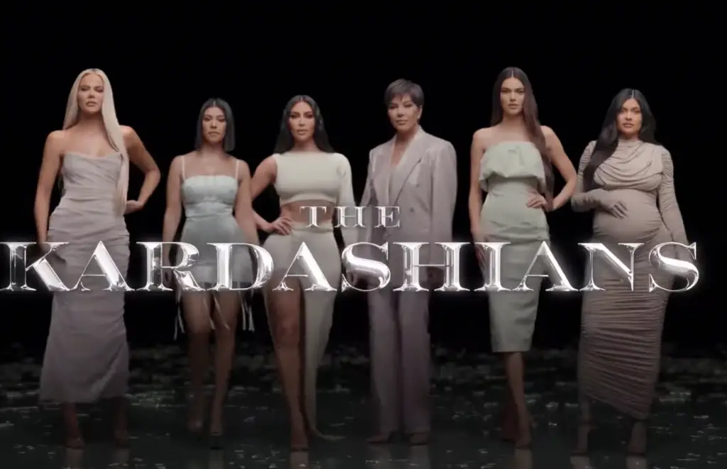 the kardashians lined up against a dark backdrop
