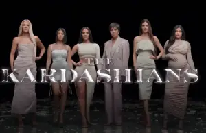 the kardashians lined up against a dark backdrop