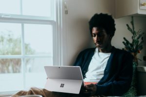 in article about using psychology tips for your study sessions, someone sitting on a bed with a tablet