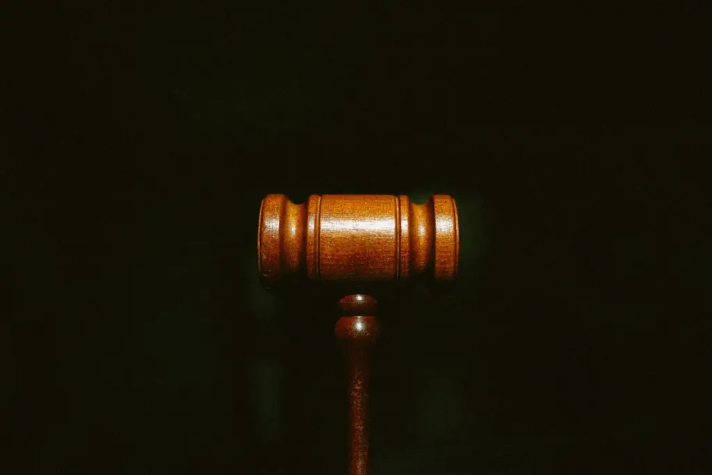 in an article about the depp v. heard case, a photo of a gavel against a black background