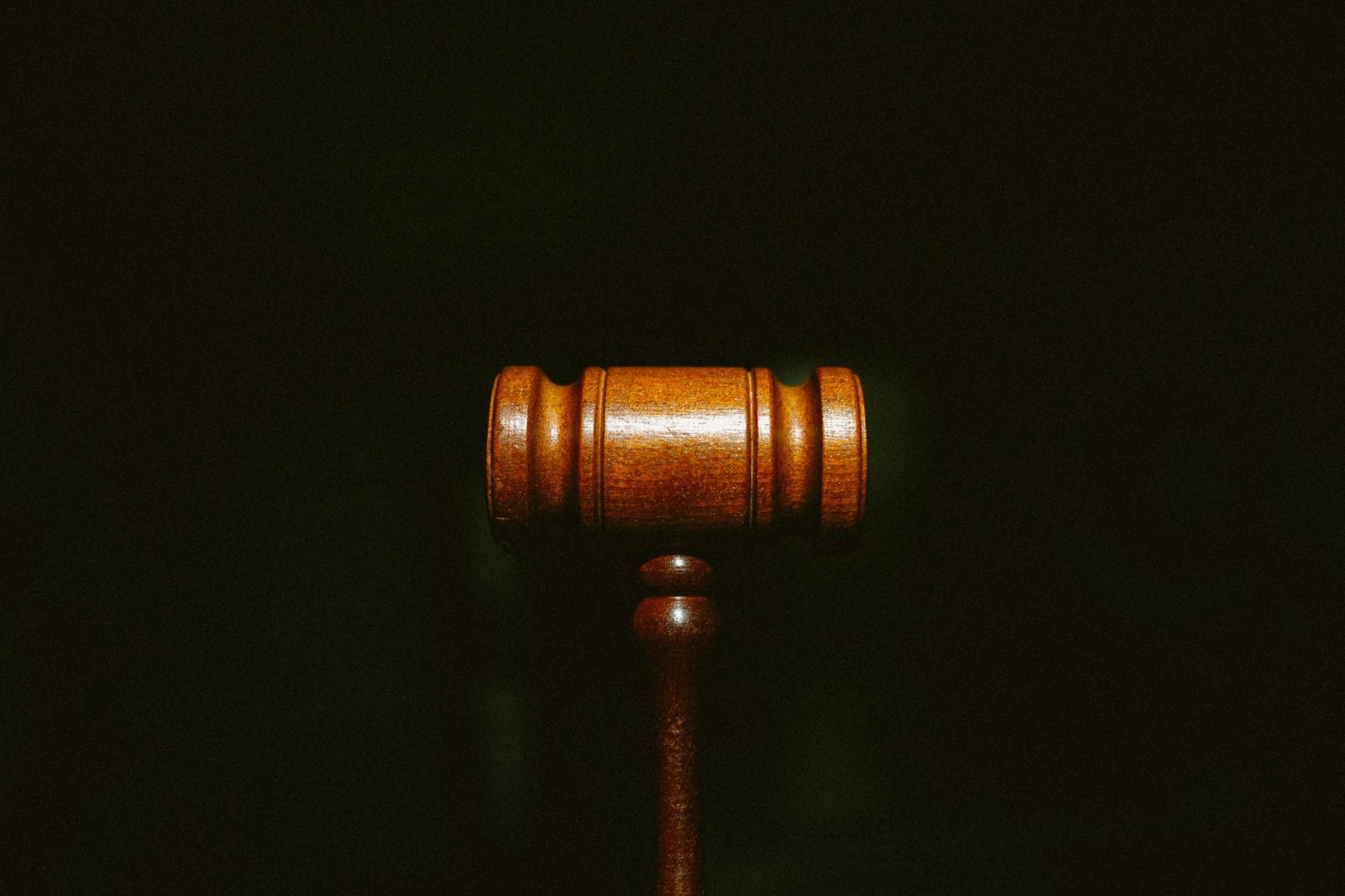in an article about the depp v. heard case, a photo of a gavel against a black background