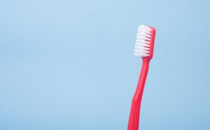 in an article about oral health, a red toothbrush