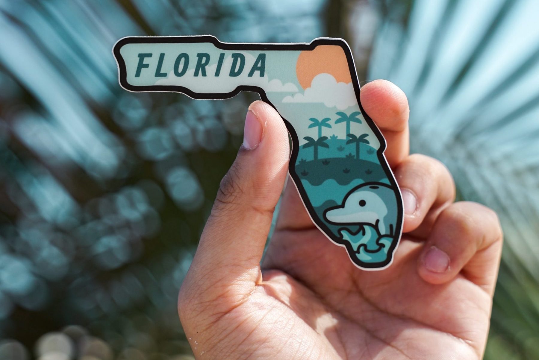 someone holding a Florida magnet