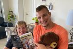 rob gronkowski with a teddy bear on a person's lap