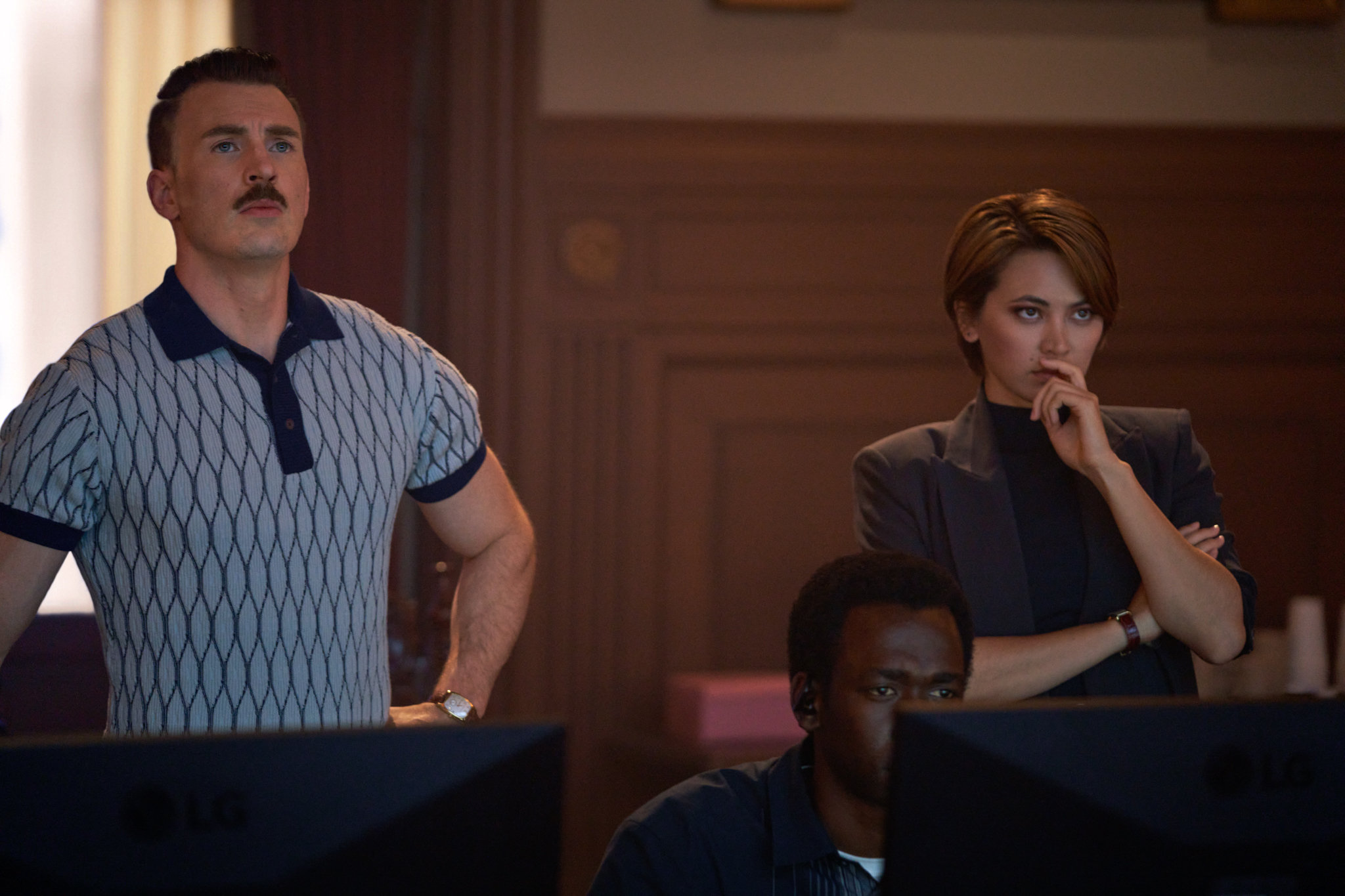 A screenshot of the gray man shows chris evans and several other actors staring off into the distance