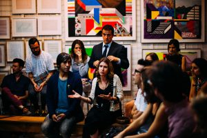 people talking in an art school classroom