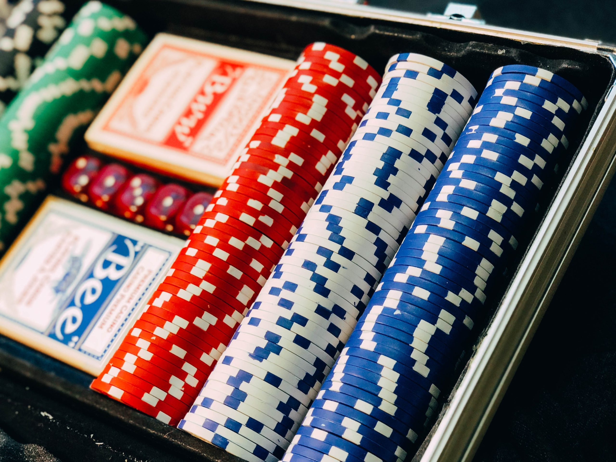 in article about online gambling, chips and cards in a case