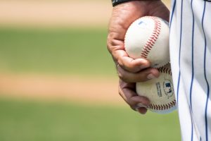 in article about sports betting in Kansas, a baseball player holding two baseballs