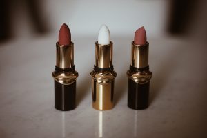 An article on Glossier has a picture with three lipsticks in different colors.