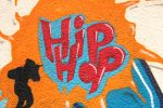 An article about sampling in hip hppe, an illustration of a mural with the words hip hop and a silhouette of a singer.